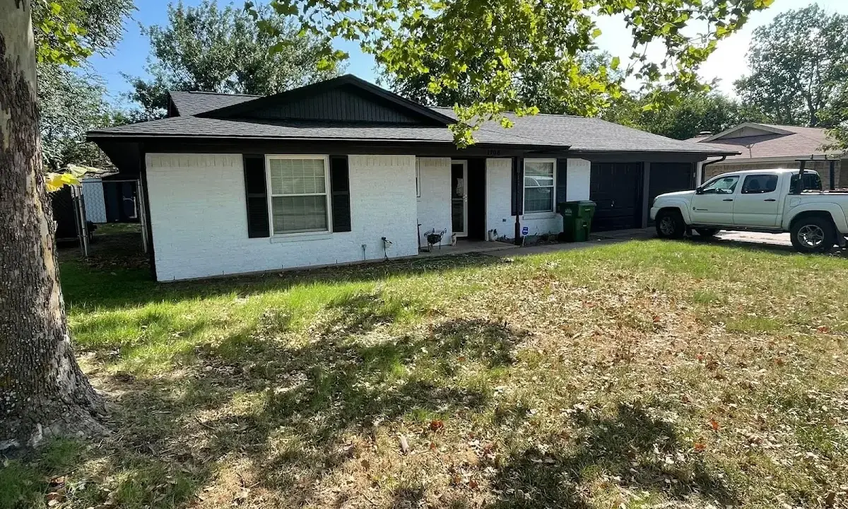 Professional roofing crew working on a residential roof in Tracy